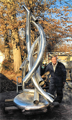 Aldon Addington stands with his sculpture