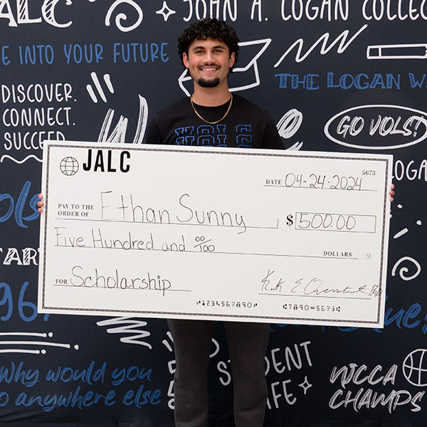 Student with scholarship check