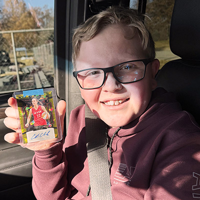 Reid Endres shows his Caitlin Clark autographed rookie card.